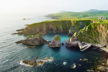 Papier Peint photo autocollant Atlantic Ocean Road Dunquin or Dun Chaoin pier, Ireland's Sheep Highway. Aerial view of narrow pathway winding down to the pier, ocean coastline, cliffs. Popular location on Slea Head Drive and Wild Atlantic Way.