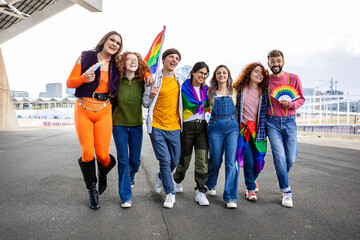 Happy diverse group of friends celebrating hay pride festival day month outdoors. LGBTQI community...