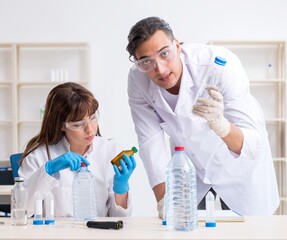Two chemists working in the lab