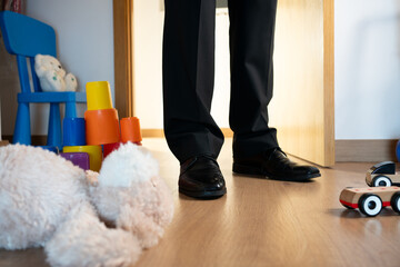 A classic white teddy bear abandoned from the floor at night in a child's bedroom when the door...