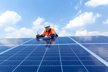 Male engineer working on checking and maintenance in solar power plant. Using radio communications....