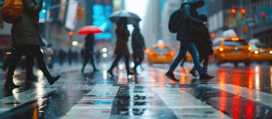 Zoom effect captured people crossing a wet city street in a picture.
