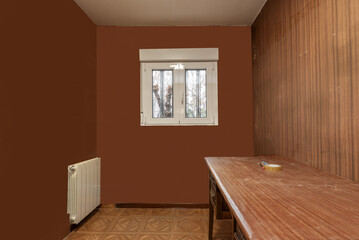 Ugly old room with dirty furniture in a house in need of comprehensive renovation with white...