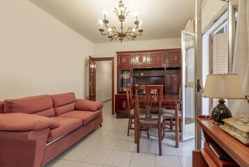 A small living room in a house with old-fashioned wooden furniture