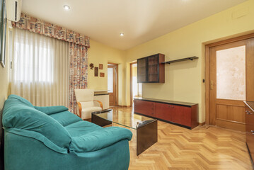 A living room with access to other rooms, French oak parquet floors, a modular bookcase with black...