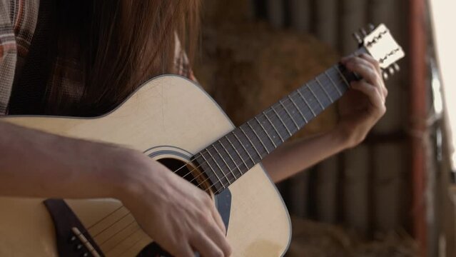 Playing classical music on acoustic guitar closeup