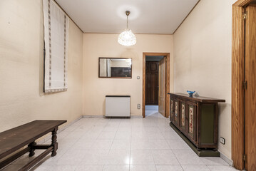 Living room with antique wooden furniture and fabric blinds on the windows, mirror on the wall and electric heat accumulator