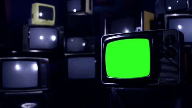 An Old Television Green Screen Among Many Retro TVs. Blue Dark Tone. Zoom In. 4K Resolution.