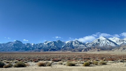 Snow-capped mountains seen from freeway near Independence, California. Motion blur on foreground...
