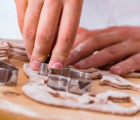 Young man cooking cookies in kitchen