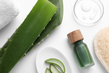 Flat lay composition with cosmetic products and cut aloe leaves on white background