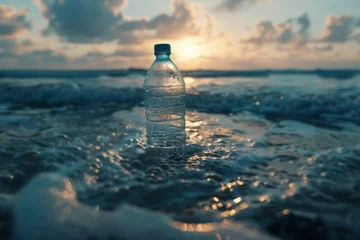 Foto op Plexiglas Bottle of mineral water on the beach at sunset. Selective focus. © Christiankhs