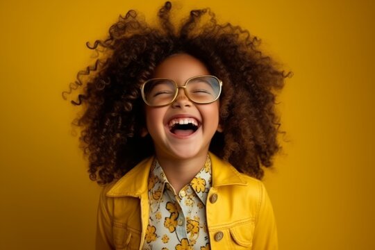 Portrait of a happy african american little girl in eyeglasses over yellow background