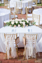 Painted Wooden Mr and Mrs Sweetheart Table Wedding Reception Signs Decor Hanging on Bride and Groom Gold Chivari Chairs with Pink and White Floral Arrangement Vertical