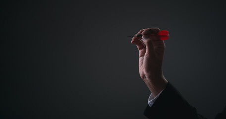 Executive marketing Businessman hand holding red arrow dart and throwing to the center target dart...