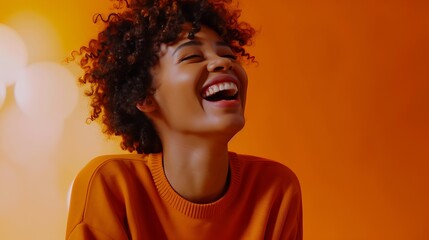 Glad overemotive dark skinned lady with curly hairstyle laughs happily expresses sincere emotions being amused by friend dressed in orange casual jumper models in studio alone with moc : Generative AI - obrazy, fototapety, plakaty