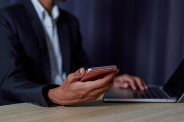 Businessman using internet technology around the world connecting Chatbot Chat with AI. Businessman using mobile app and laptop..