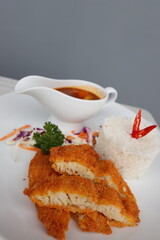 delicious japanese food dori fish katsu with curry and rice on a white plate