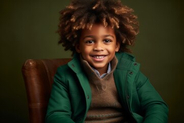 Portrait of a cute african american little boy in a green jacket.