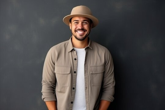 Portrait of a handsome young man with hat smiling at the camera
