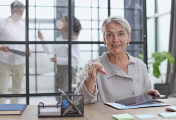 woman writes notes. working at the office at the computer