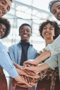 a group of successful business diverse people in the office stands embracing