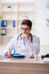 Young male doctor working in the clinic