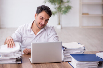 Young male employee working in the office