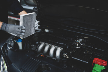 Hand mechanic holding car air conditioner filter for check and clean dirty or fix repair heat have...
