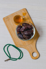 Dried dates, tea and wooden tray