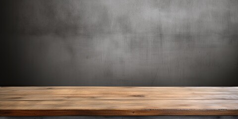 Wood-textured table top on a background of a gray concrete wall. - obrazy, fototapety, plakaty