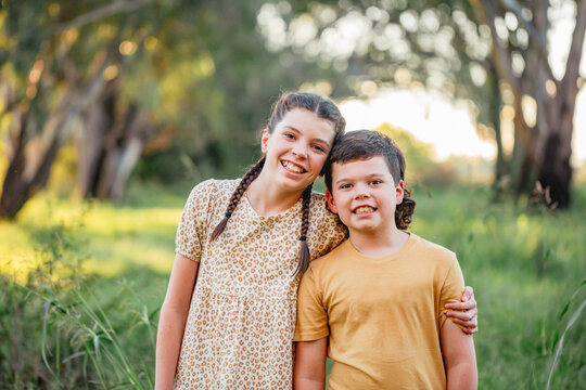 Portrait of bother and sister standing together in Australian country bush setting