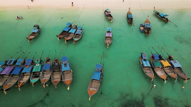 a group of boats are lined up in a row in the water