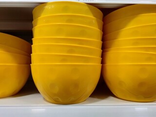 yellow bowls display on the shelf.