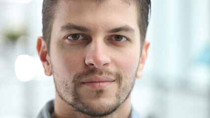 Fototapeta premium A man's face looks at the camera in close-up