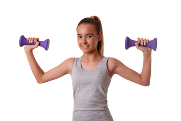 Horizontal shot of satisfied motivated teen girl has regular training raises arms with dumbbells, isolated on white. Sport concept