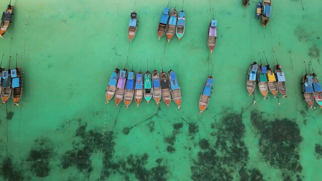 an aerial view of a group of boats in the water