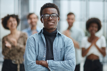 smiling African American business man with executives working in background