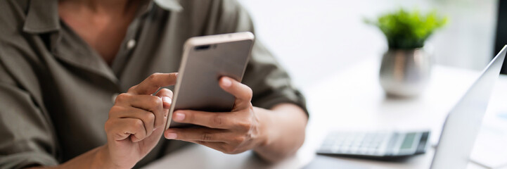 Asian casual businesswoman use smartphone to checking growth finance report of new startup project
