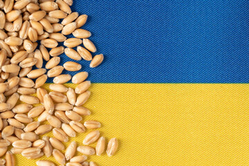 Wheat grains on the yellow and blue flag of Ukraine, Ukrainian grain crisis, global hunger crisis...