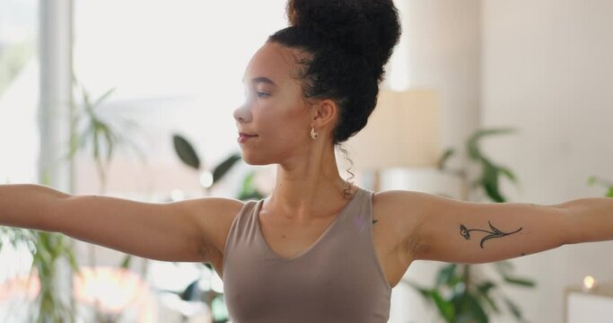 Yoga, woman and stretching in a home studio for health and wellness in the morning with care. Spiritual, zen and African female person relax and calm for practice in a living room in warrior pose