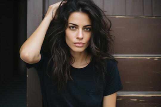 Portrait of a beautiful young brunette woman in a black T-shirt