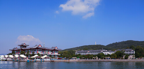 A lakeside view of Beihai Park, a famous tourist destination in Beijing, in the summer. In the...