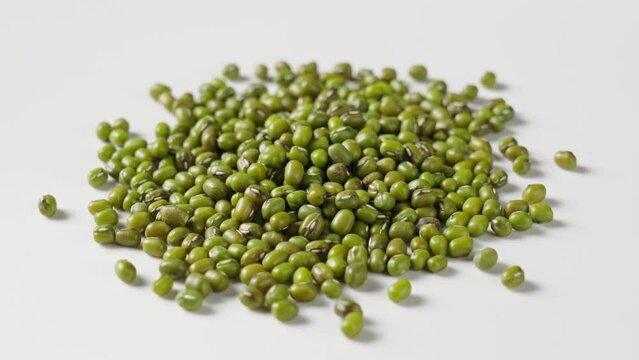 raw mung beans seeds on white background.