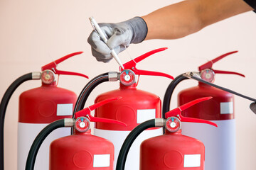 Hand checking fire extinguisher for fire prevention protection and prevent and safety rescue or use...