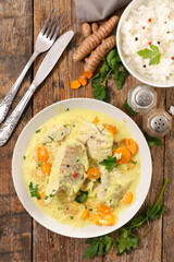 seafood meal, fish fillet cooked with coconut cream, spices and carrot