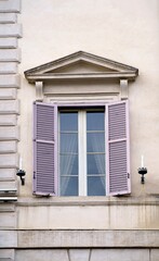 Windows of Rome. Classic old wooden windows with shutters in a public place on a city street or in an urban environment.