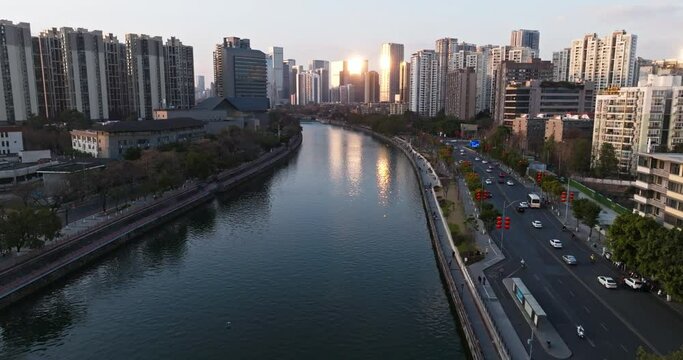 Aerial cityscape of Chengdu city at sunset by the river