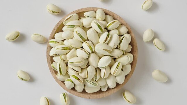 roasted salted pistachio nuts on white background.