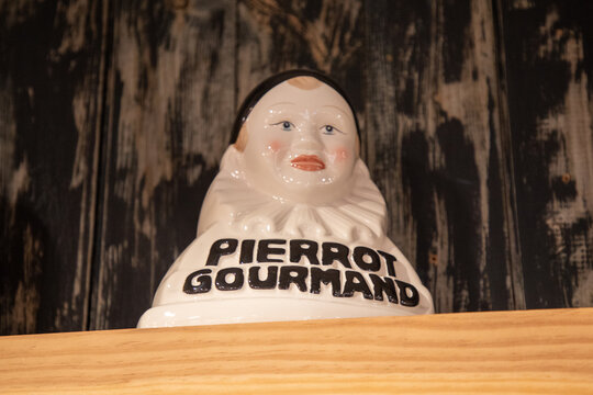 pierrot gourmand logo text and brand sign onlollipop display for children in clown bust display confectionery